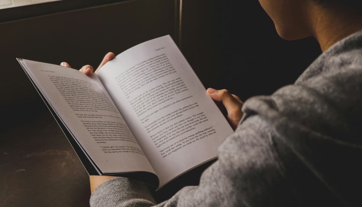 Person reading peacefully in a calm setting, suggesting relaxation and mental wellbeing