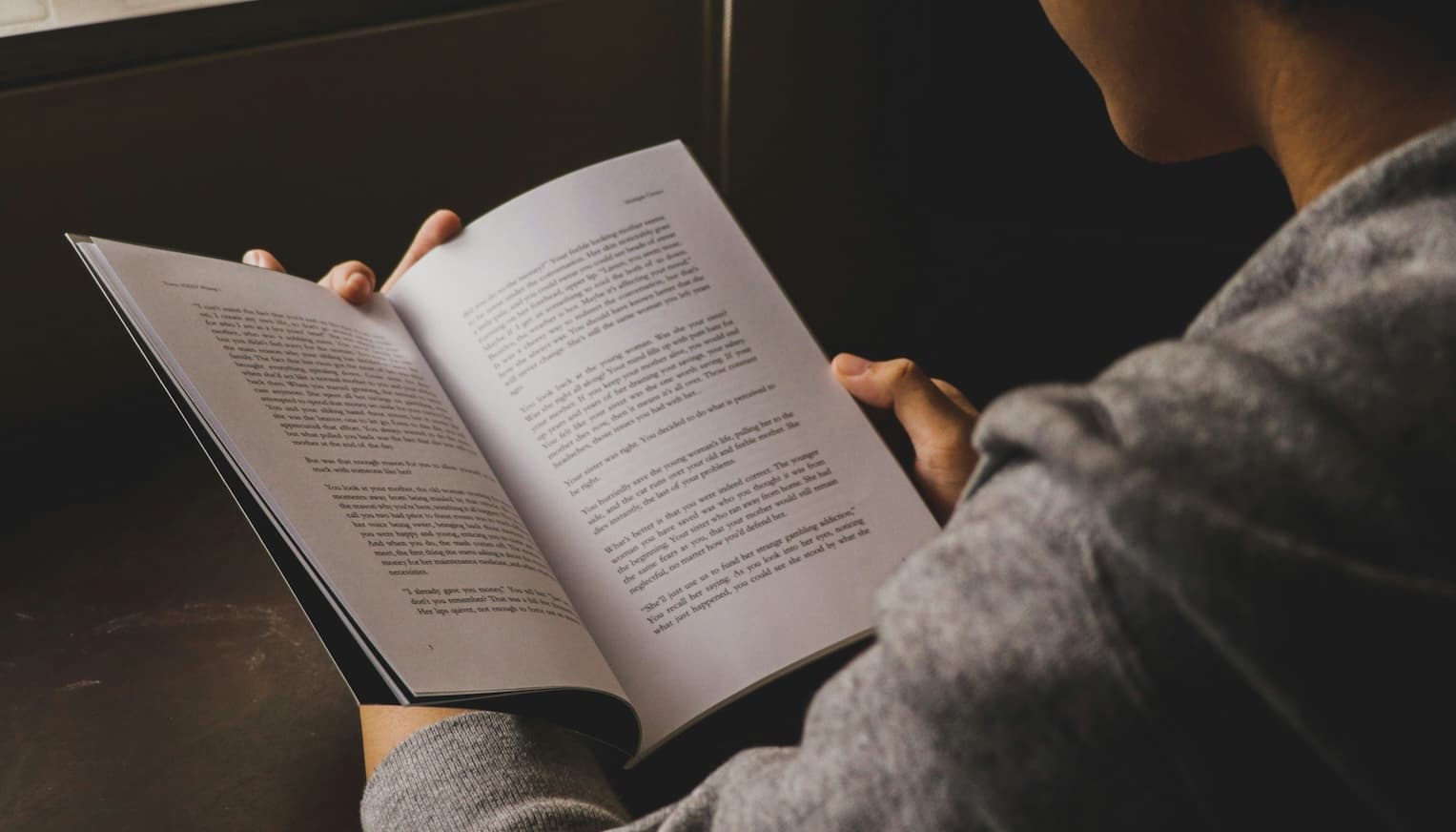 Person reading peacefully in a calm setting, suggesting relaxation and mental wellbeing
