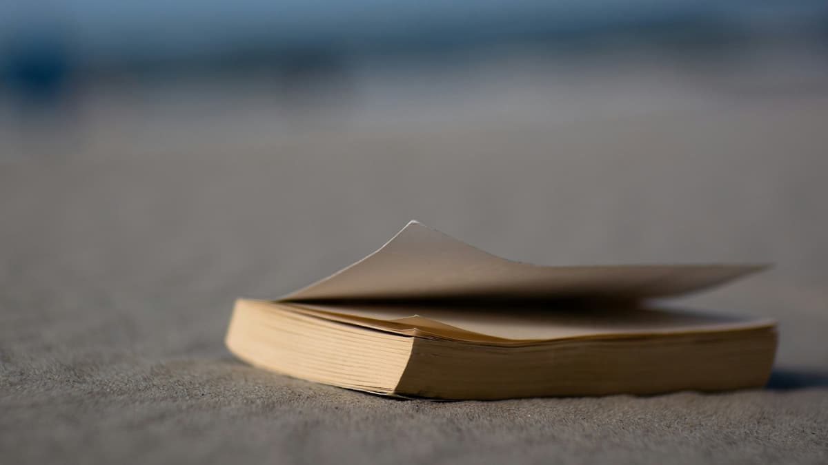 Closed book set face-down on textile