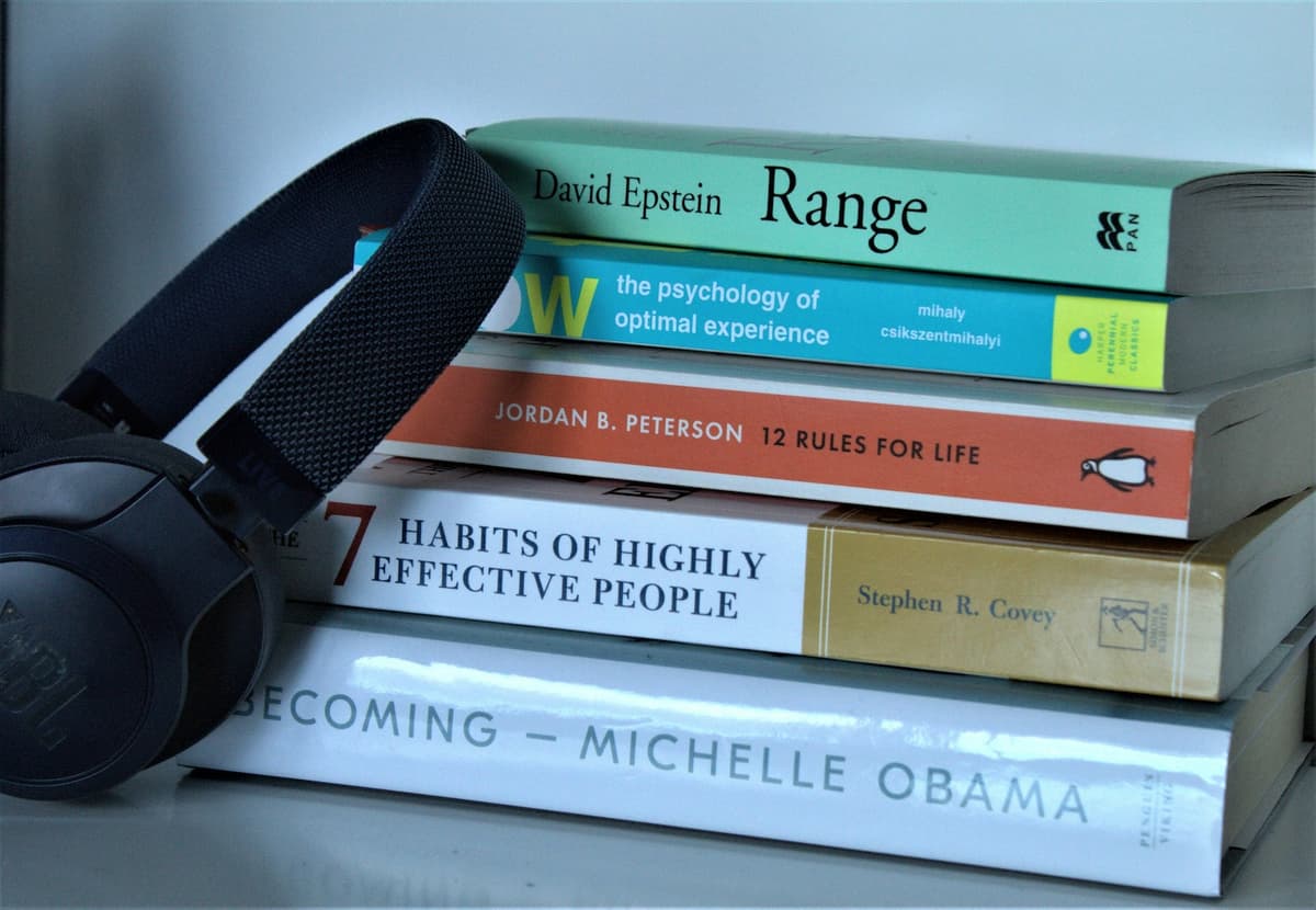 Headphones resting on a stack of books