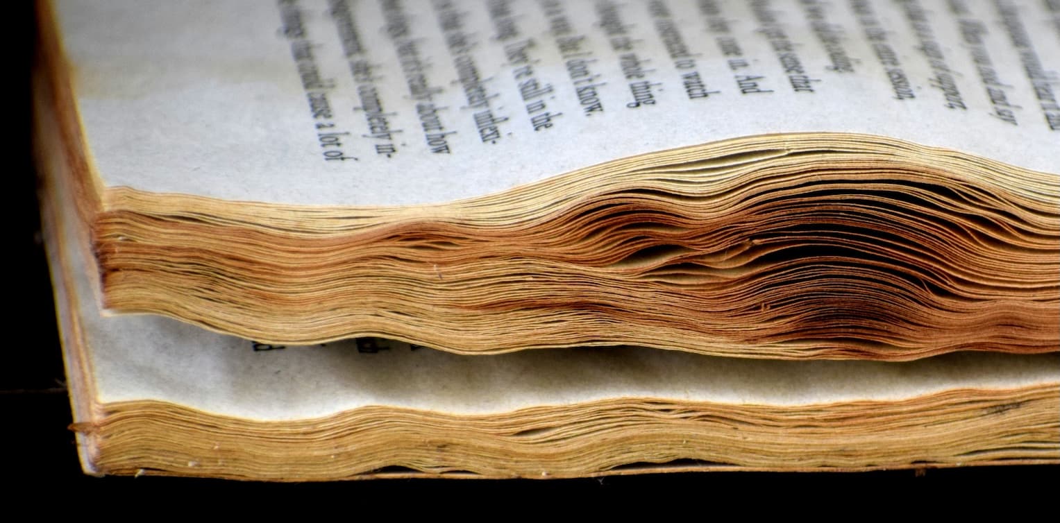 Worn book curling pages suggesting it has been read multiple times