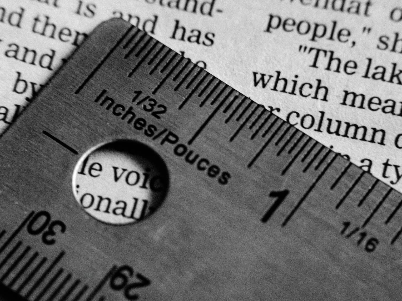 Open book with a ruler on top, suggesting measurement and metrics
