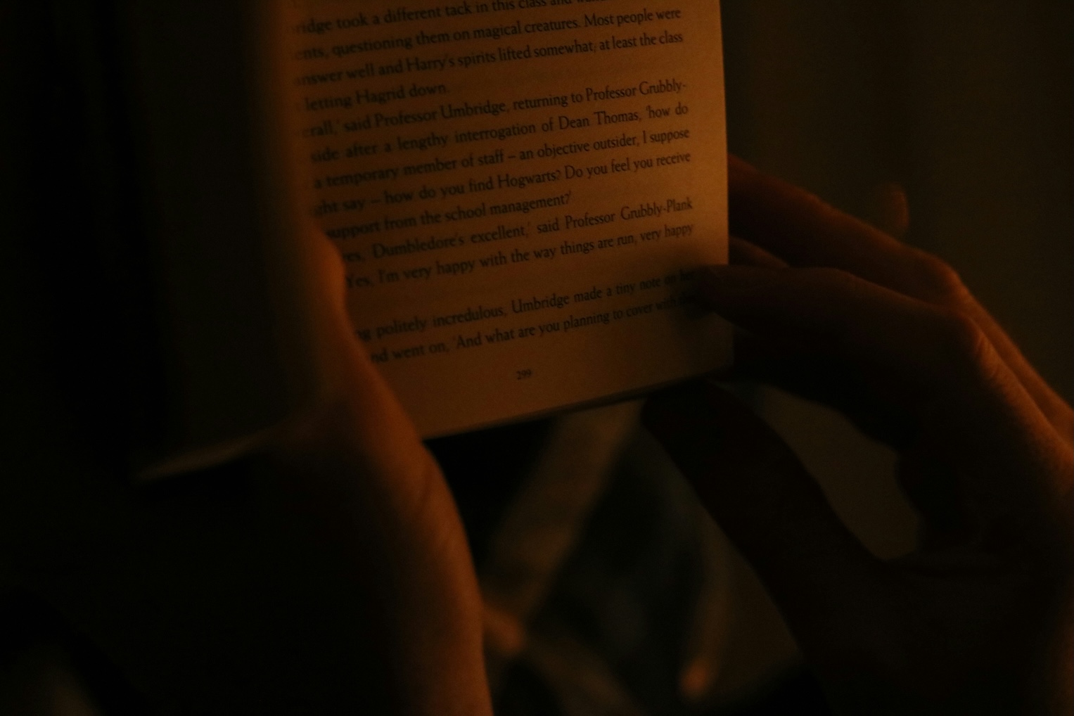 Hand turning a single page slowly, soft natural light, no rush
